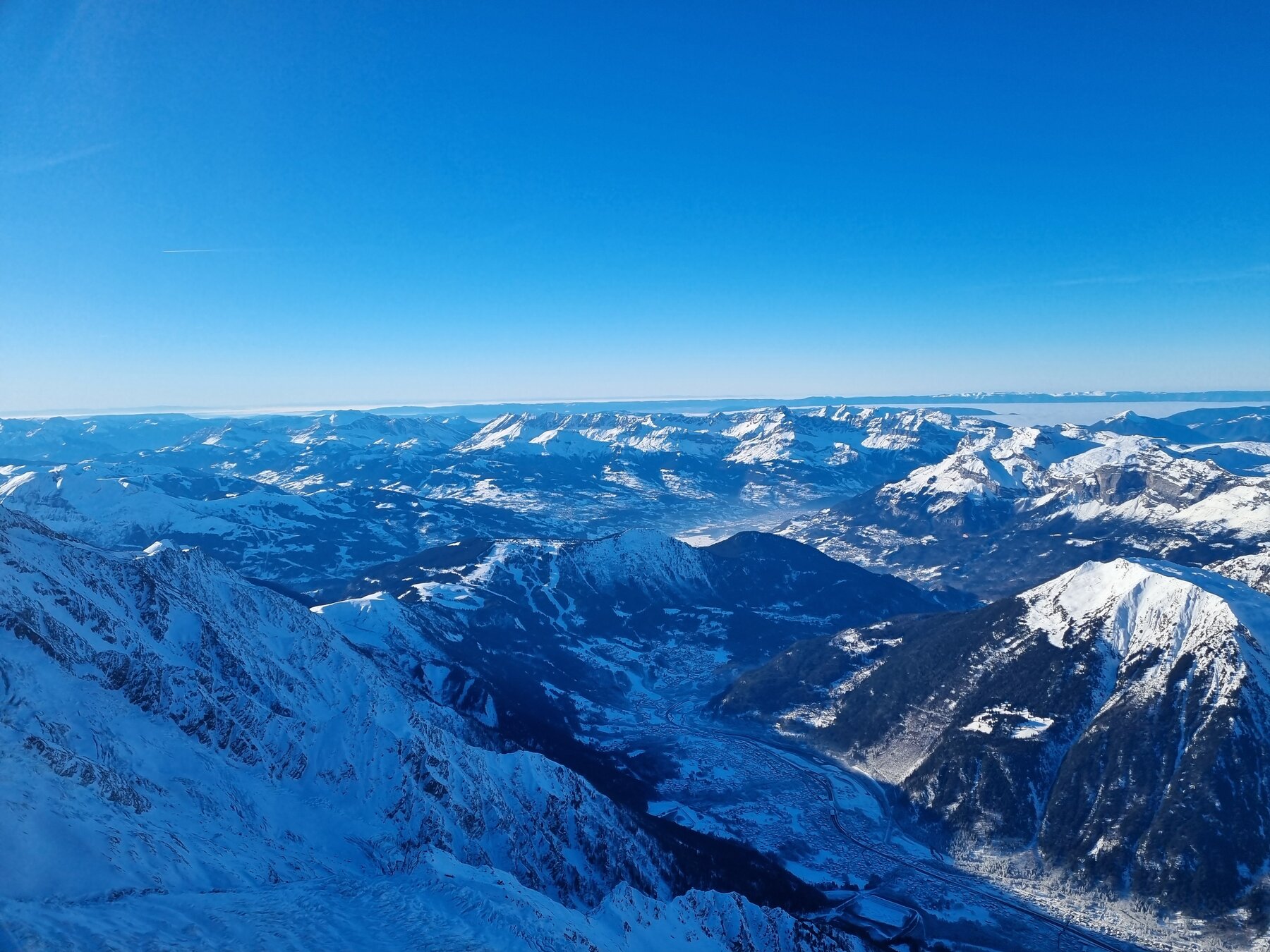 Panoramic view of snowy mountains from above